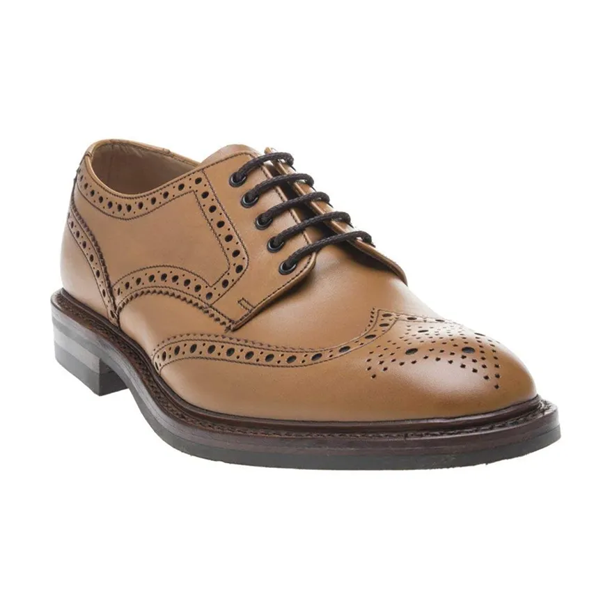 Tan leather brogue dress shoe with black laces and decorative perforations on the toe and sides.