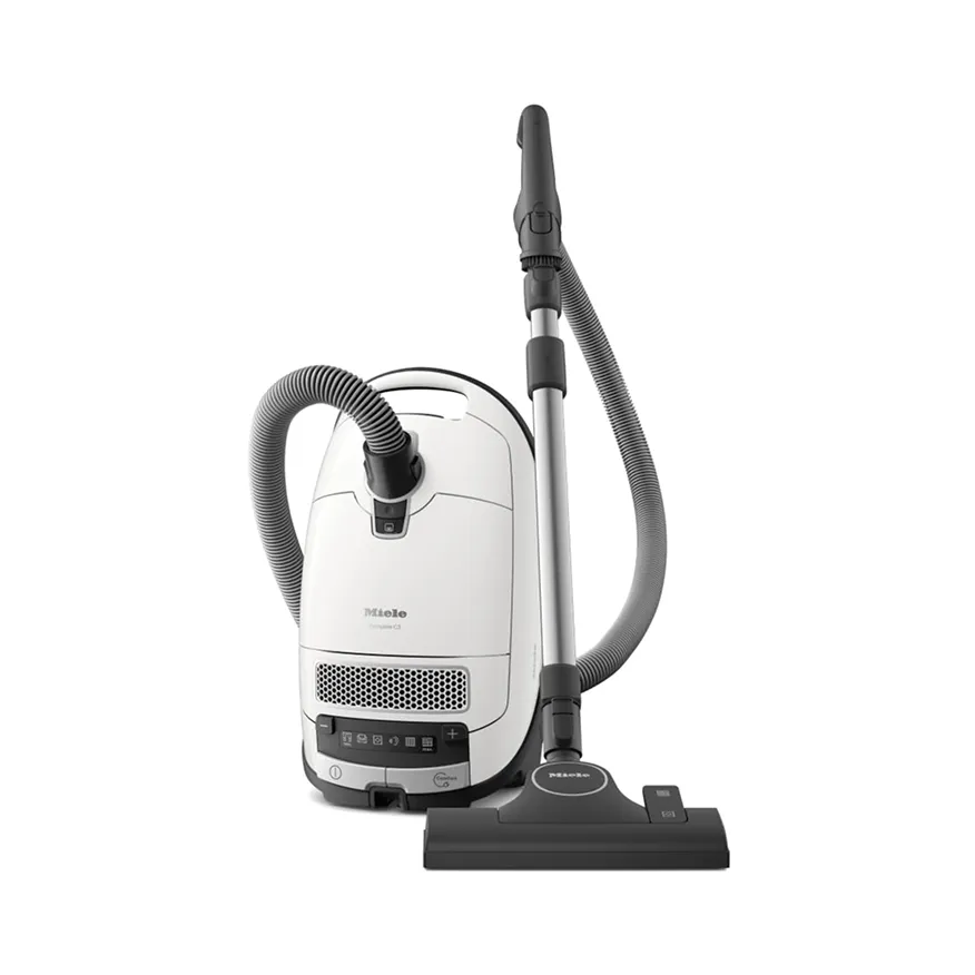 White Miele canister vacuum cleaner with black hose and floor attachment on a white background.