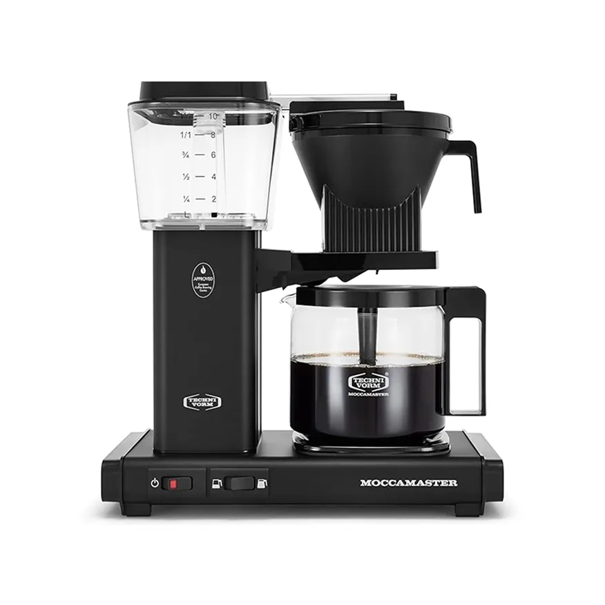 Black Technivorm Moccamaster drip coffee maker with glass carafe filled with coffee and clear water reservoir.