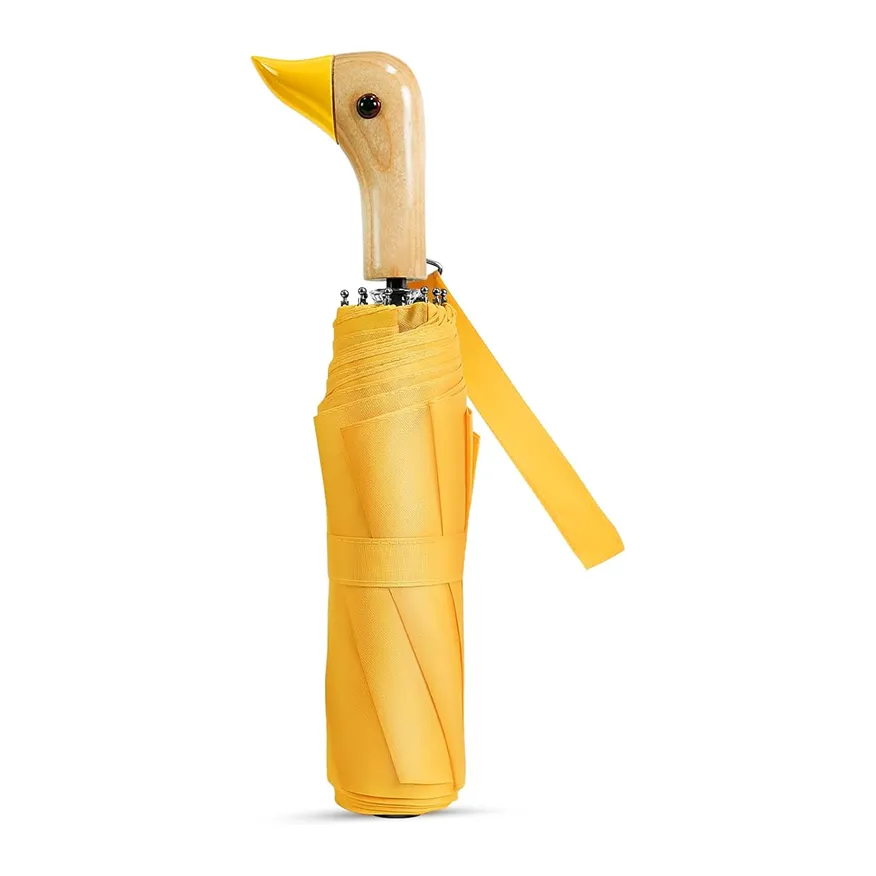 Closed yellow umbrella with a wooden handle shaped like a bird's head.