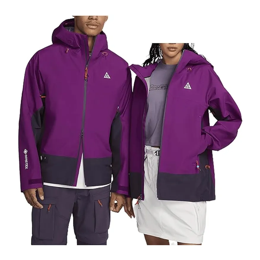 Man and woman wearing matching purple and black Nike ACG Gore-Tex jackets, the man paired with dark pants and the woman with a white skirt.