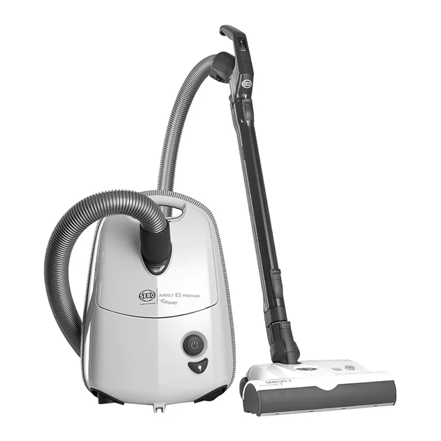 White SEBO Airbelt E3 Premium canister vacuum cleaner with attached hose and floor nozzle.