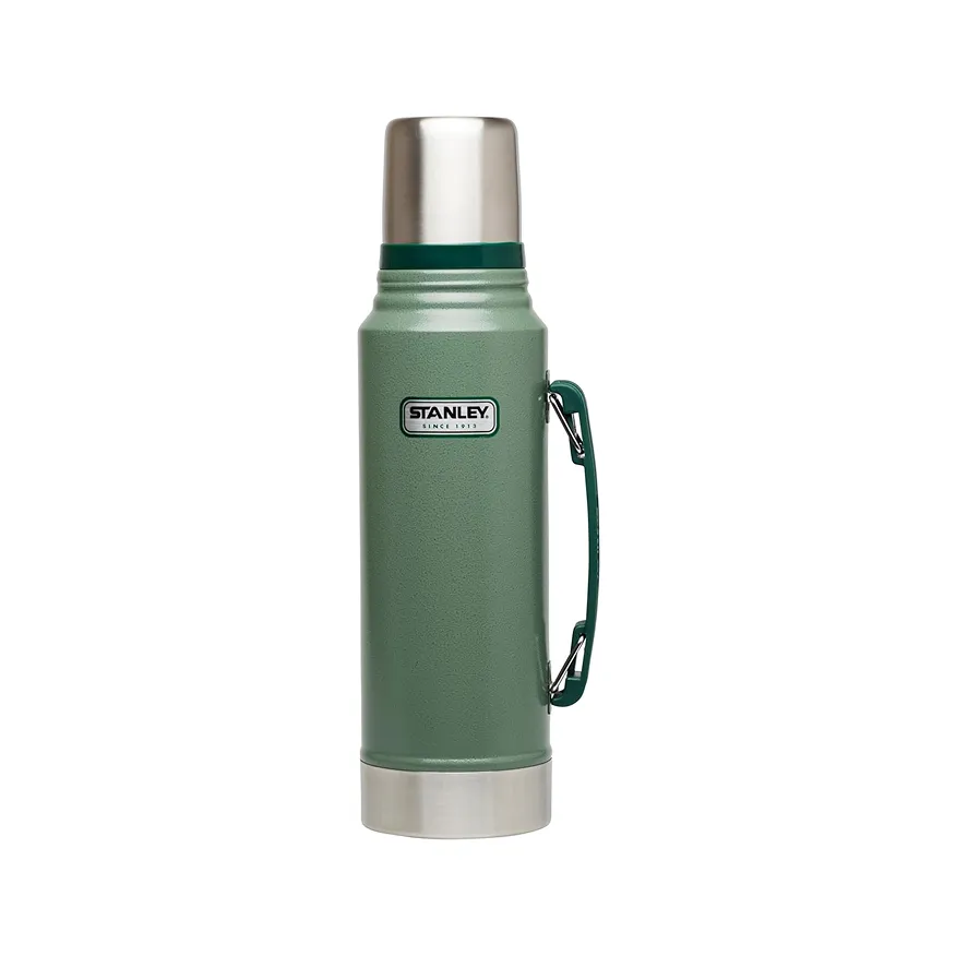 Green Stanley thermos with a metal lid and base, featuring a side handle.